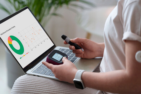 Woman with diabetes examining sugar level on laptop at home