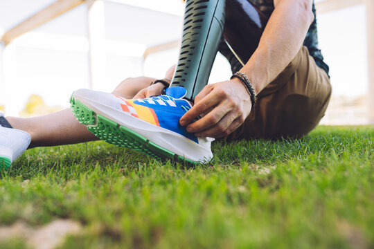 Man with amputed leg wearing shoes on grass