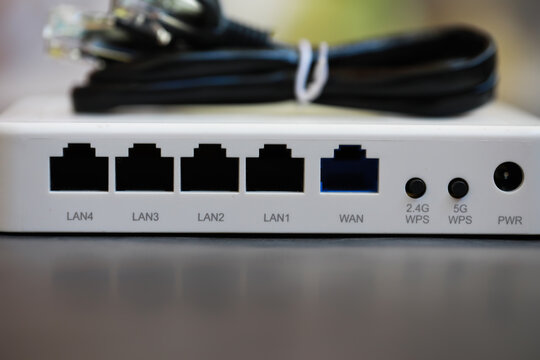 Close-Up of Modem Router with LAN and WAN Ports and Coiled Cable