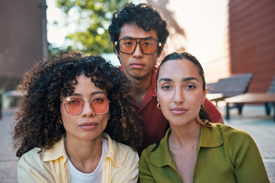 Friends pose for a portrait outdoors