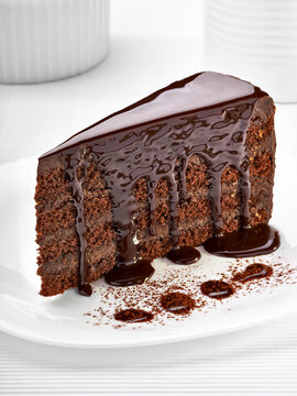 Piece of cream chocolate cake on white plate