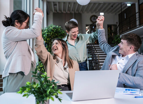 Happy business team celebrating success together in a modern office