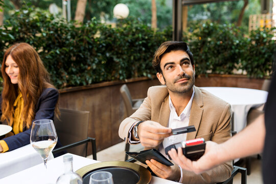 Man paying with credit card in a restaurant
