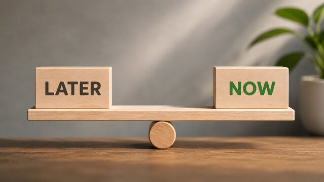 Wooden balance scale weighing words later and now showing the importance of taking immediate action and overcoming procrastination