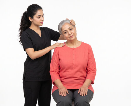 Young Indian physiotherapist assisting senior Indian woman with seated shoulder mobility rehabilitation exercise isolated on white background for physiotherapy orthopedic care and senior wellness