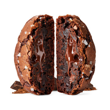 Molten chocolate brownie cookie split open with melted gooey center and sea salt flakes isolated on transparent background