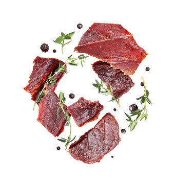 Dried pieces of beef with rosemary and allspice in the air on a transparent background