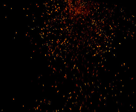 Fiery sparks explode against a pitch-black background