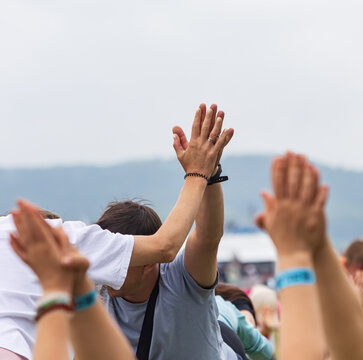 Hands raised high in joyful celebration
