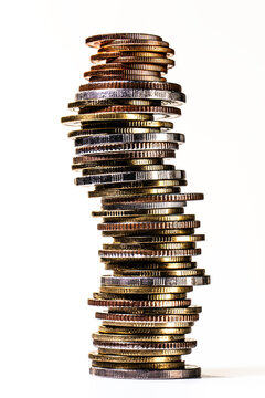 Leaning Stack of Assorted Coins Symbolizing Financial Risk and Investment Growth
