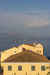 Fototapeta premium Corfu Town buildings overlooking Ionian Sea with boats