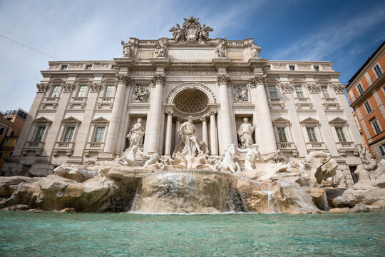 Wide angle panoramic view of the majestic Trevi Fountain with turquoise water and waterfall in Rome, Italy