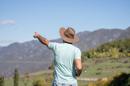 Traveler walking along scenic trail in beautiful natural landscape with mountains and forest, enjoying adventure, freedom, exploration, and peaceful outdoor journey.