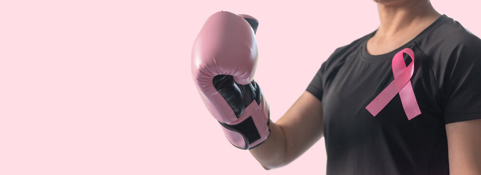 Breast cancer awareness pink ribbon for women health in October month, female patient fighting with tumor on pastel rose pink background