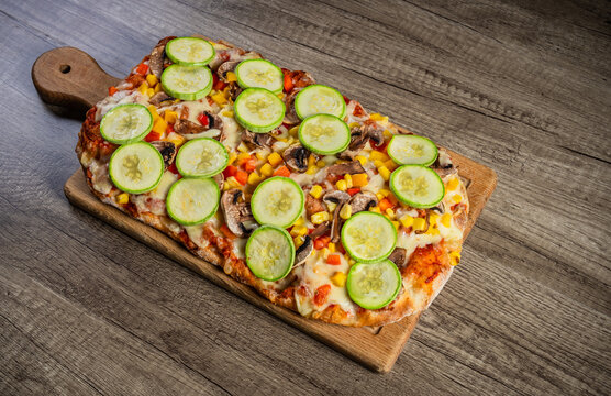 Fresh homemade pizza topped with melted cheese, tomato sauce, and flavorful ingredients, baked to a golden crust, showcasing delicious comfort food and traditional home cooking.