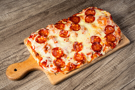 Fresh homemade pizza topped with melted cheese, tomato sauce, and flavorful ingredients, baked to a golden crust, showcasing delicious comfort food and traditional home cooking.