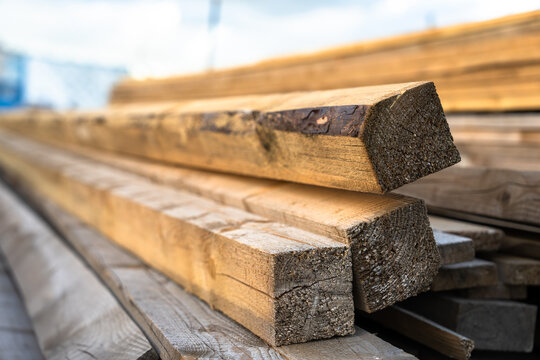 Wood processing workshop producing construction materials, featuring cutting, shaping, and preparing timber for building projects, representing industrial manufacturing and carpentry work.