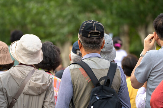 Group of tourists exploring city streets with maps and cameras, urban sightseeing, cultural travel experience, architecture discovery, and international tourism concept.