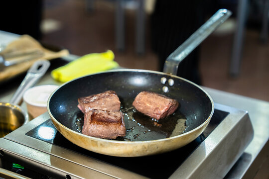 Professional chef cooking in a modern kitchen, preparing fresh ingredients with precision and skill, demonstrating culinary expertise, creativity, and high-quality food preparation techniques.