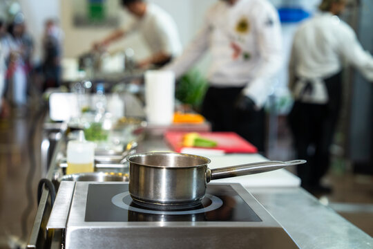 Professional chef cooking in a modern kitchen, preparing fresh ingredients with precision and skill, demonstrating culinary expertise, creativity, and high-quality food preparation techniques.