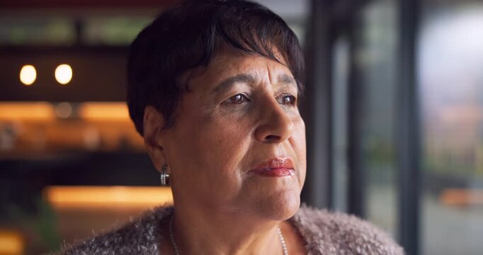 Serious, thinking and senior woman in home with deep thoughts, perspective or remember past memory. Retirement, reflection and person by window for view, introspection or flashback with vision