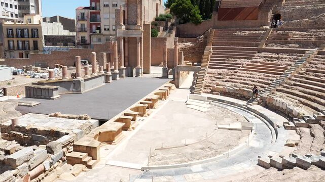 High angle view of the historic roman theatre of cartagena, a well preserved ancient archaeological site and popular tourist attraction in murcia, spain, on a sunny day with blue skies