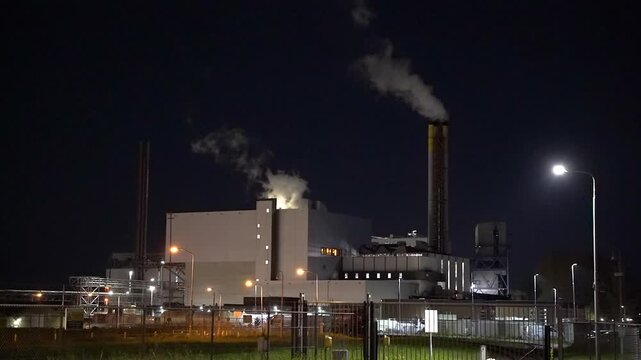 HVC Waste-to-Energy Plant in Dordrecht, Netherlands, Operating at Night with Emissions Visible from Chimneys.
