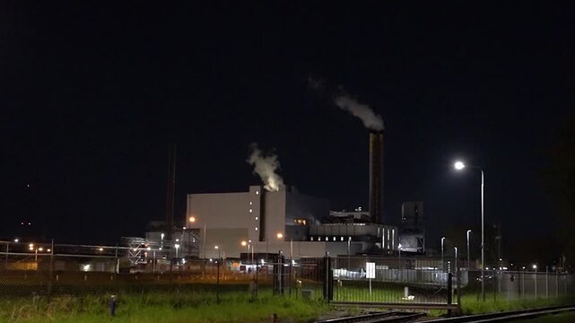 HVC Waste-to-Energy Plant in Dordrecht, Netherlands, Operating at Night with Emissions Visible from Chimneys.
