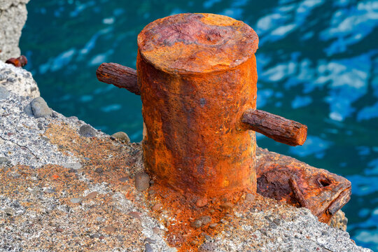 Old, rusting bollard at the harbor