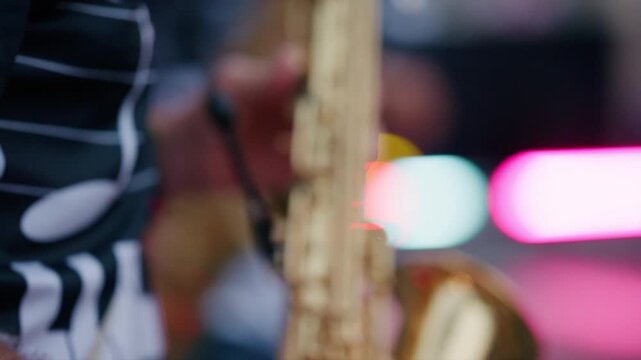 Street band musician playing a brass saxophone, creating vibrant music during an outdoor festival or street performance