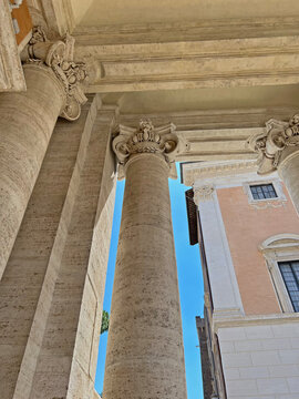 Classic Roman architecture with travertine columns and ornate Baroque details. Capturing classical architecture, heritage, and tourism in Rome.