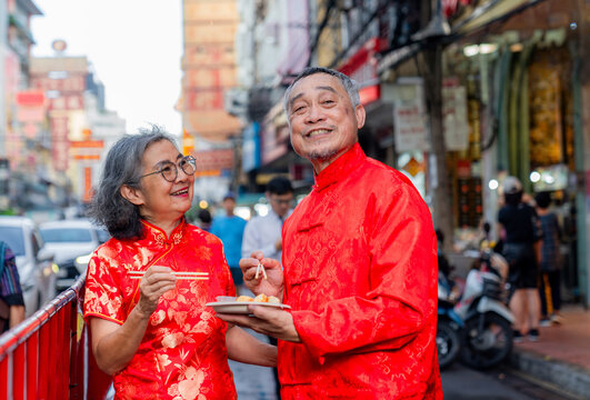 Couple enjoys street food during festival in Chinatown