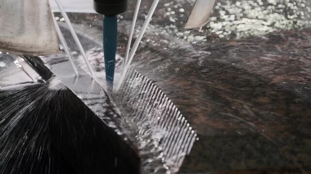 Industrial cnc machine carves patterns into a slab of granite, showcasing the precision and artistry of modern manufacturing