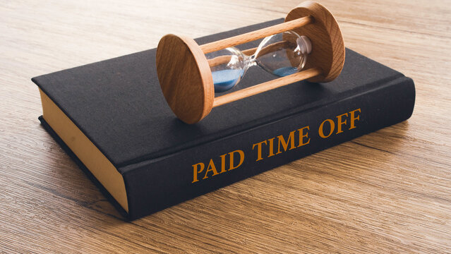 Paid Time Off Text on Book Cover with Hourglass