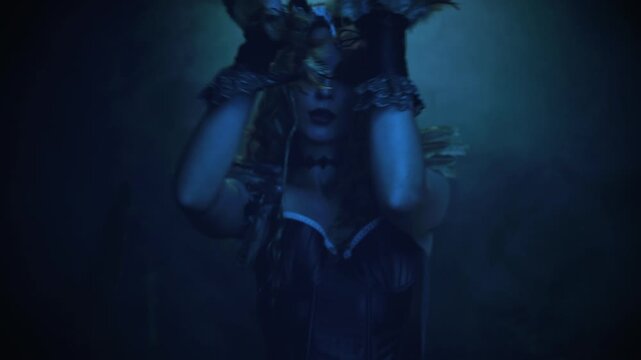 Fantasy characters fashion model posing dansing vawing hand in dark night forest moon light. sharp claws black nails evil gothic fairy woman owl, bird costume. sexy face eyes lips fairy tale elf girl