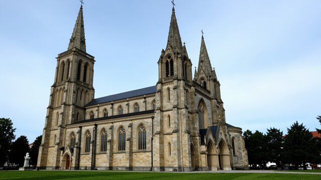 Magnificent Gothic Cathedral: A grand Gothic cathedral with towering spires and intricate architectural details stands proudly under a clear blue sky.