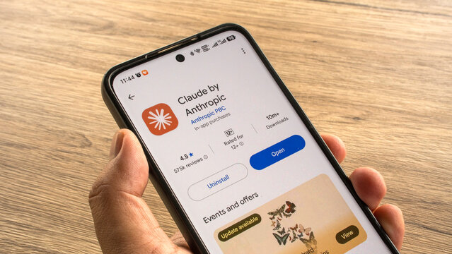 KULIM,MALAYSIA - JULY 13TH,2026 : Close up view of a hand holding a smartphone showcasing the Claude by Anthropic AI assistant application on the official Google Play Store app market.