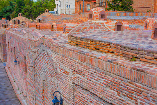 A red brick bathhouse building in the historical part of Tbilisi