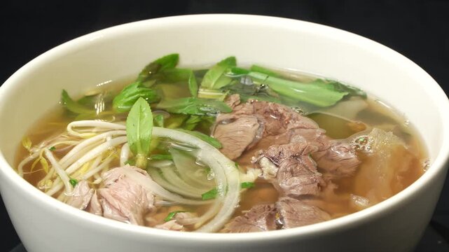 Finished Vietnamese Pho bowl rotating, showing delicious ingredients.