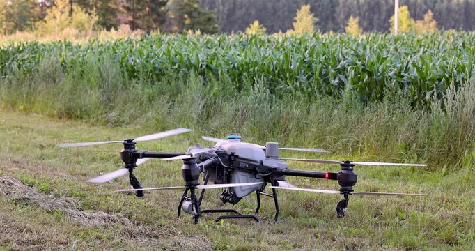 Agricultural spray drone take off over crop field for precision farming