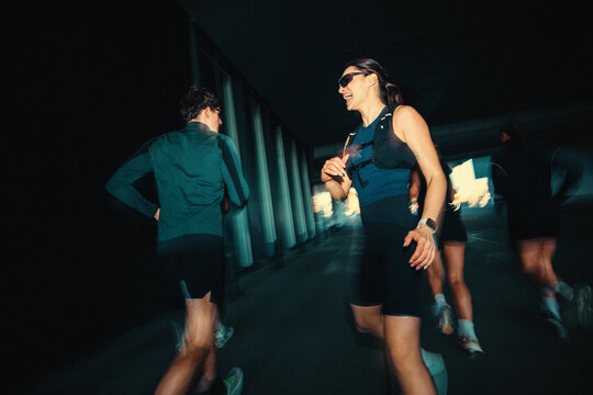 Under an urban bridge, running keeps the young adult group training together
