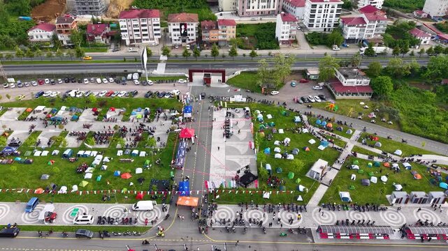 4K cinematic drone glides above a classic car and motorcycle festival, capturing rows of vintage vehicles, motorcycles, and the lively outdoor event from above.