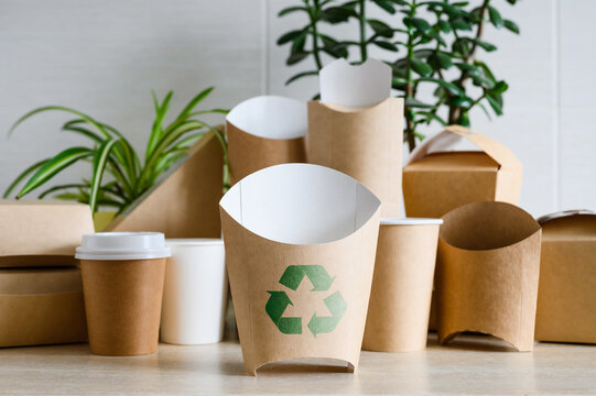Elimination of plastic packaging. Paper packaging for single-use recycling. Recycling symbol on eco-friendly packaging.