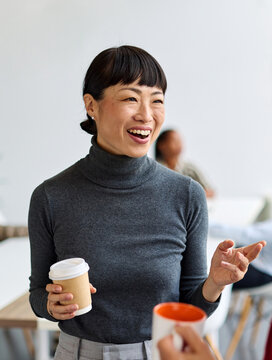 Portrait of two young business woman having a meeting or presentation and seminar standing in the office. Portrait of a young business woman talking