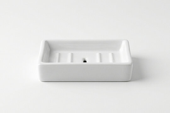 Empty white ceramic soap dish on a white background