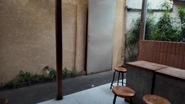 Tables and chair in the cafe, there is woman walking by