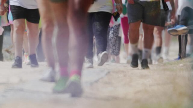 People walking in a fun walk event in a park during a sunny day in spring