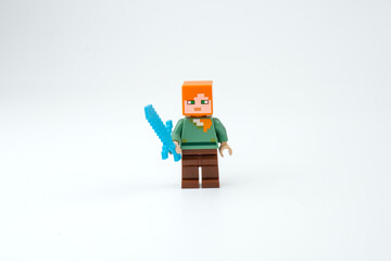 Obraz premium A Minecraft-style block toy character holds a blue sword on a white background. Suitable for pixel game characters on Apr 13, 2026 in Jakarta, Indonesia