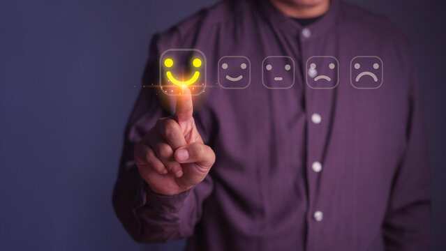 Customer satisfaction feedback concept, person select a happy smile face on rating interface. Business service quality, positive customer experience, online review, evaluation and client satisfaction.