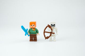 Obraz premium Two Minecraft-style block toy characters stand with a blue sword and brown bow on a white background. Suitable for pixel game toys, collectible figures on Apr 13, 2026 in Jakarta, Indonesia